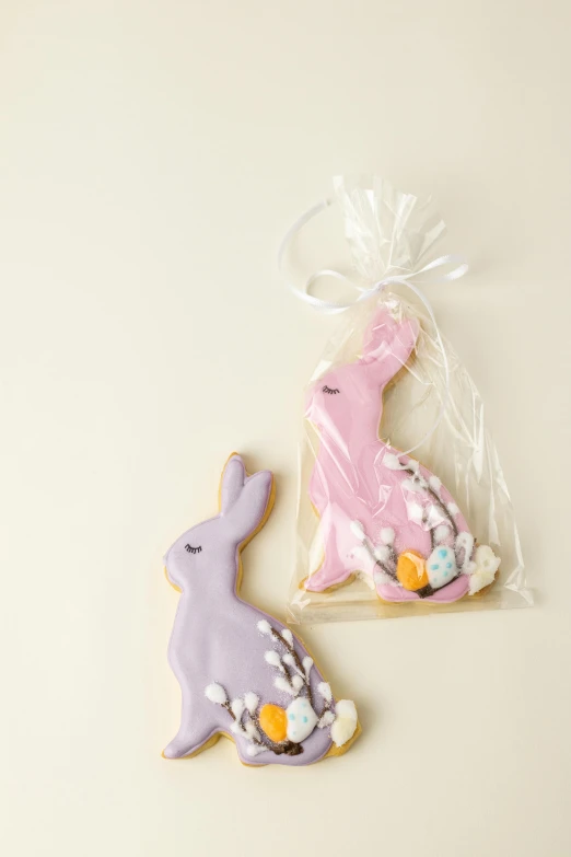 a couple of cookies sitting on top of a table, a pastel, arabesque, bunny leg, full product shot, medium, back