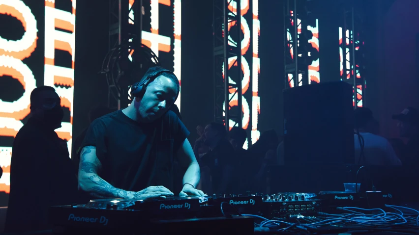 a man that is sitting in front of a keyboard, at a rave, dr dre, led screens, avatar image