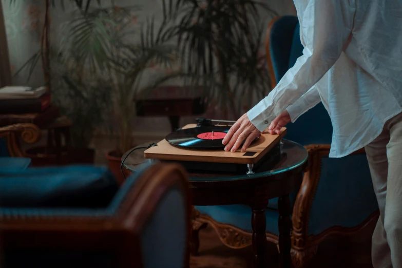 a woman cutting a piece of cake on a cutting board, an album cover, by Julia Pishtar, pexels contest winner, sitting in a lounge, turntablist, [ cinematic, hand controlling