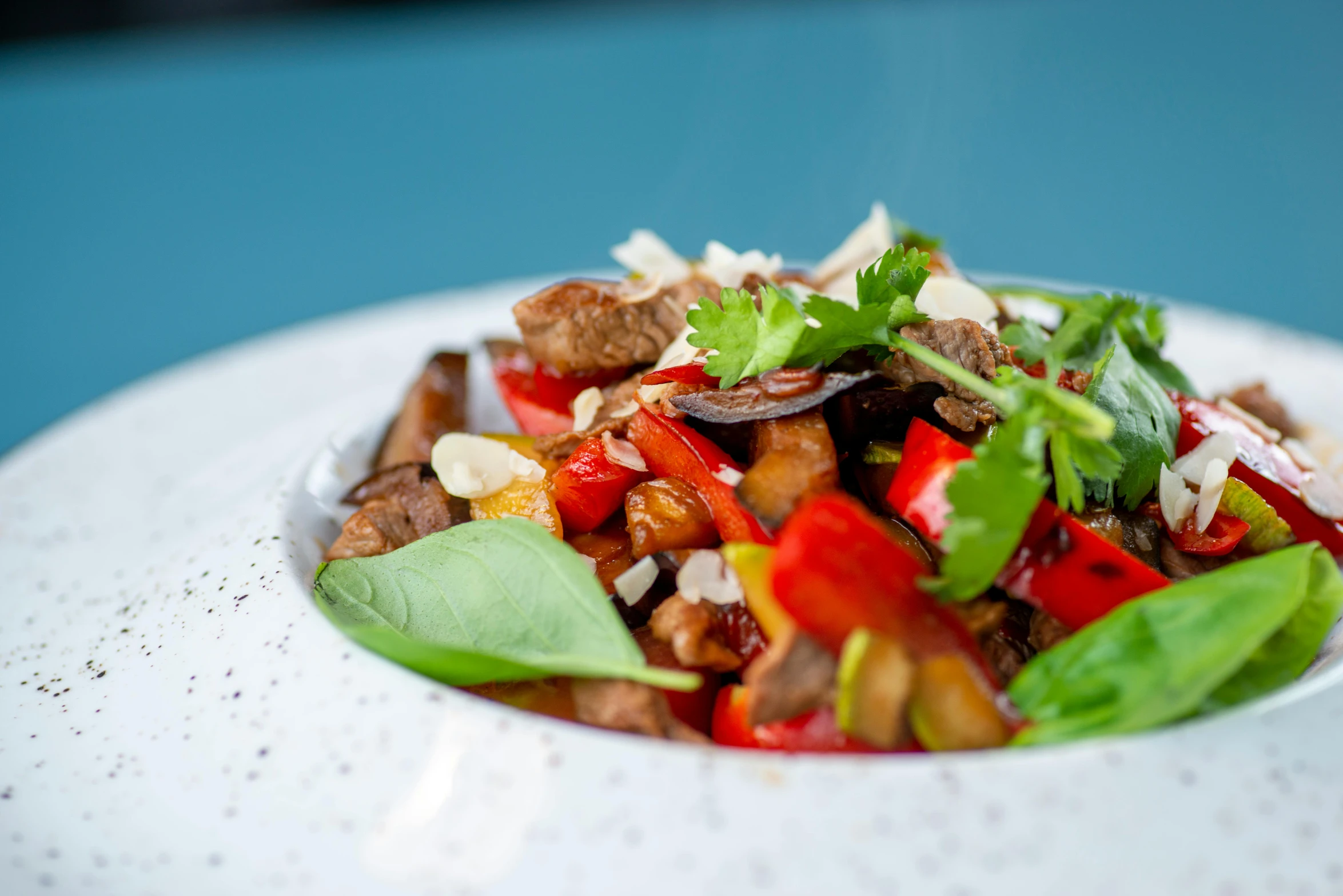 a close up of a plate of food on a table, by Emma Andijewska, lomo saltado, basil leaves instead of leaves, wok, profile image