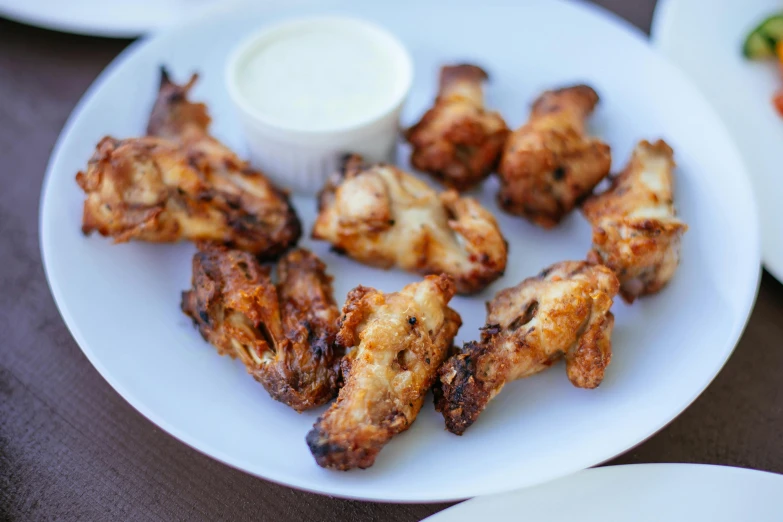 a close up of a plate of food on a table, white wings, 6 pack, al fresco, listing image