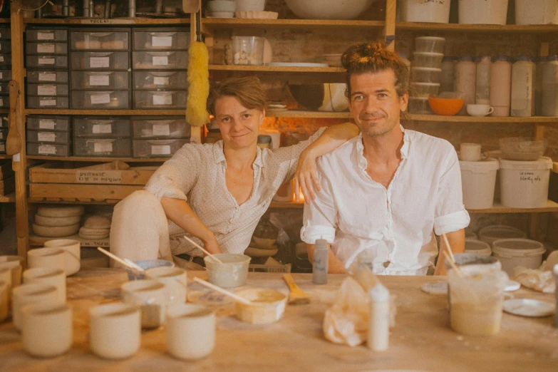 a man and a woman are sitting at a table, a portrait, arbeitsrat für kunst, white clay, emma, full of wonderful things, warm glow