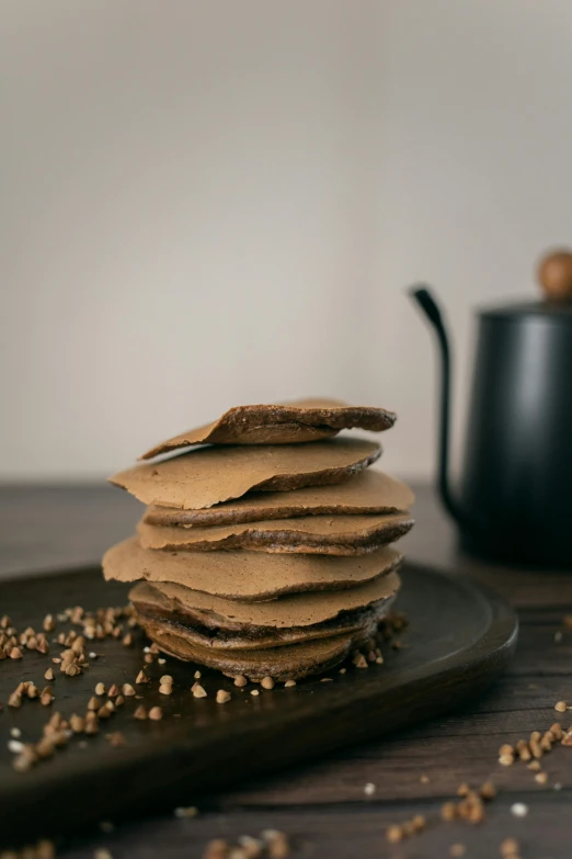 a stack of crackers sitting on top of a plate, by Jan Tengnagel, unsplash, celebration of coffee products, brown mud, pancakes, full product shot