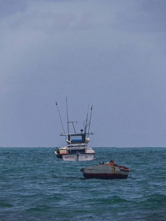 a couple of boats that are in the water, a photo, by Peter Churcher, realism, waiting to strike, puerto rico, 3 pm, south african coast