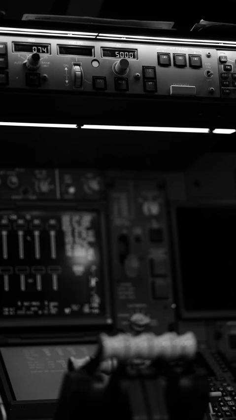 a black and white photo of a control panel, a black and white photo, unsplash, computer art, plane light, lit from the side, color”, piloting a small space shuttle