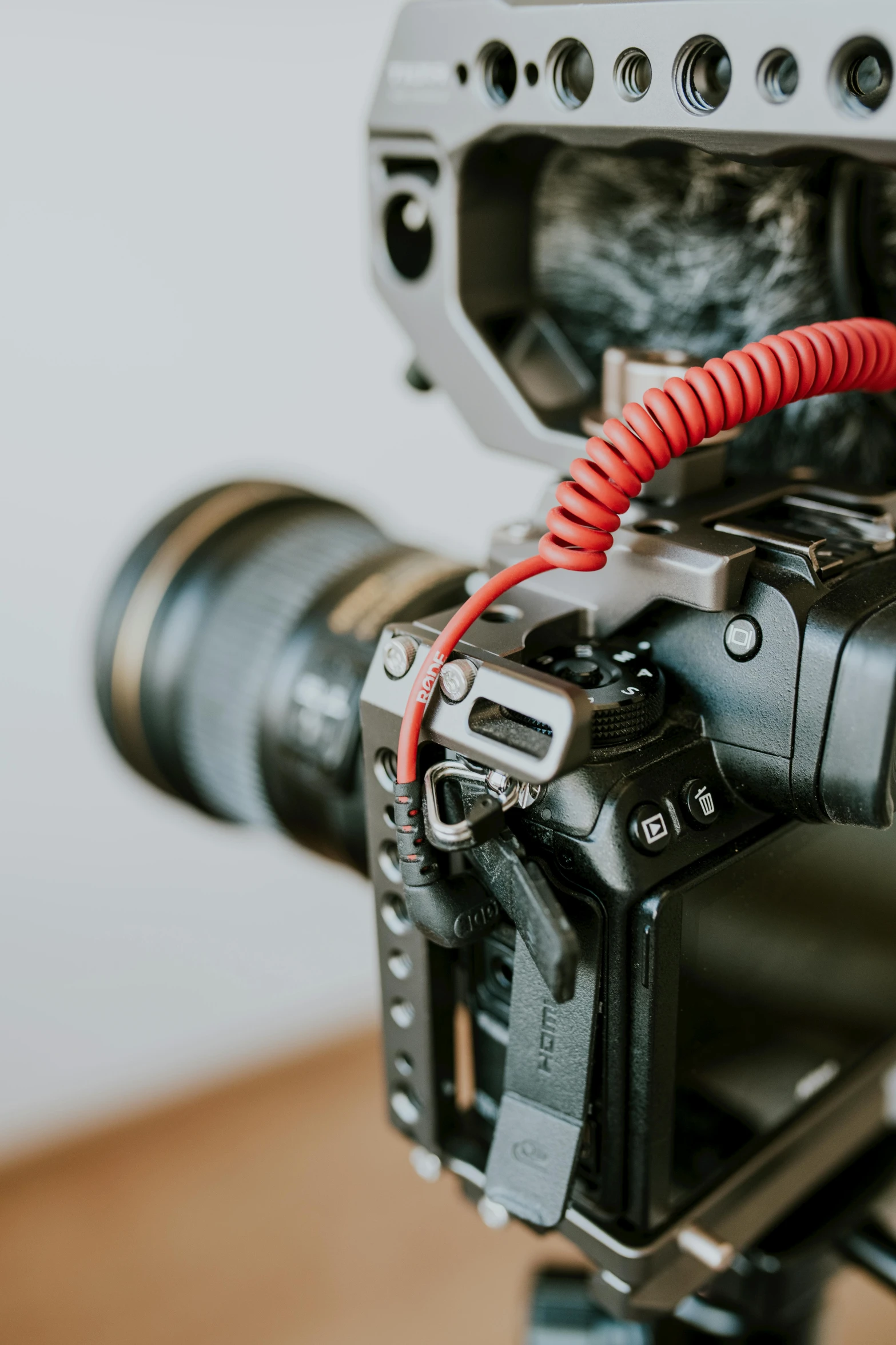 a close up of a camera on a tripod, by David Simpson, unsplash, video art, red wires wrap around, canon eos r 5, cable plugged in, 2 4 0 p footage