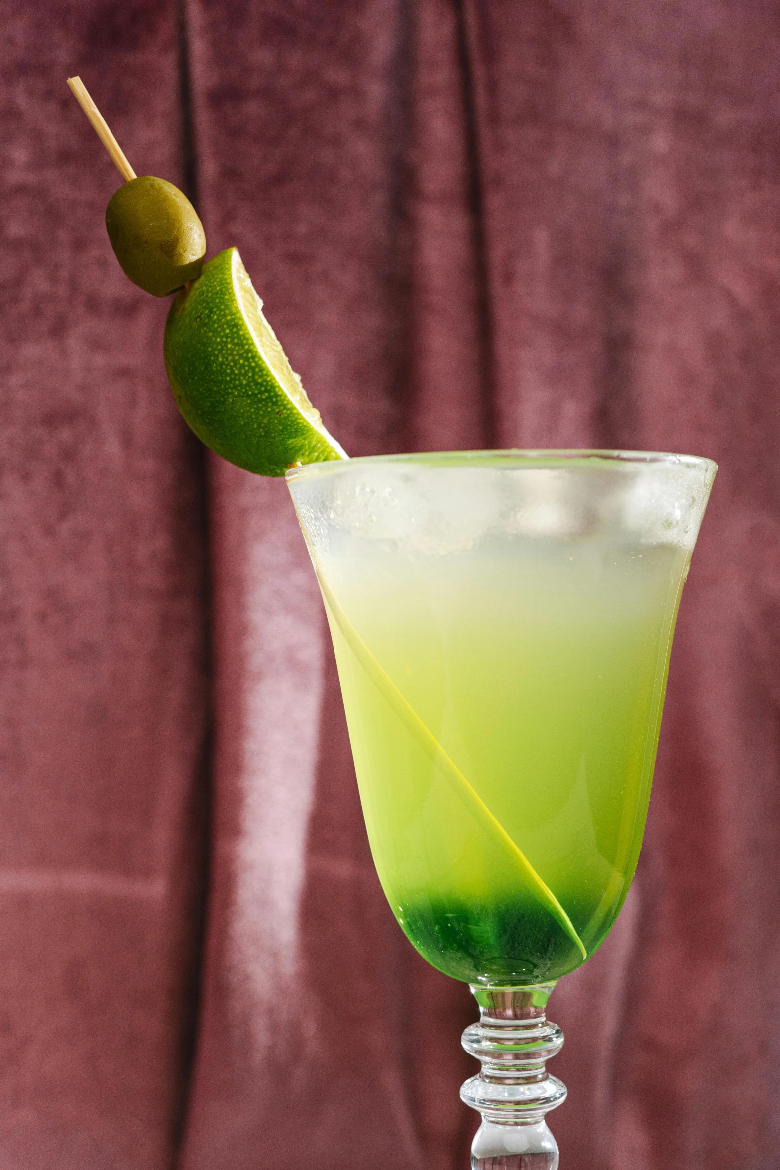 a green cocktail with a lime garnish garnish garnish garnish garnish garnish garnish ga, inspired by Ndoc Martini, 3/4 side view, olives, gradient green, zoomed in