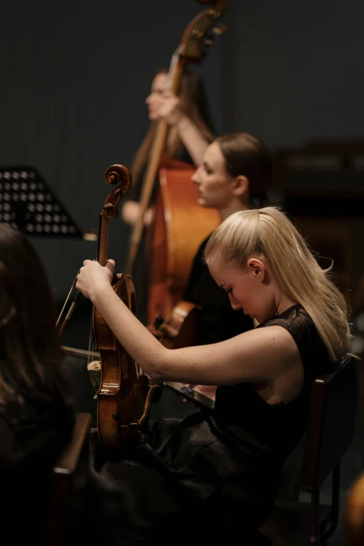 a woman in a black dress playing a cello, group mass composition, lachlan bailey, lena oxton, strathmore 2 0 0