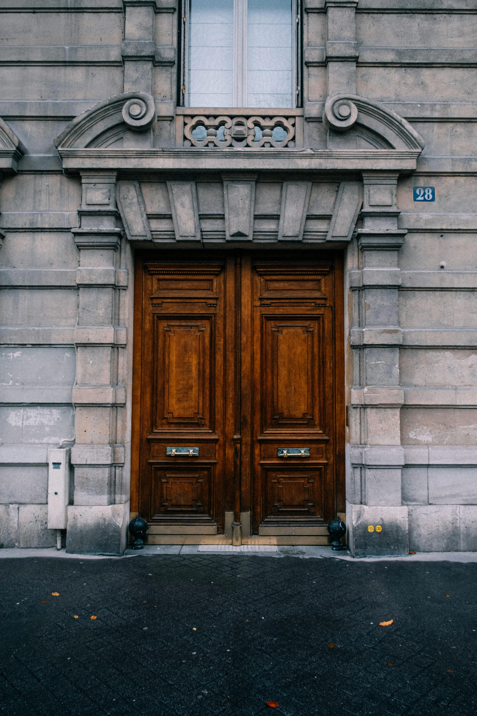 a couple of wooden doors sitting on the side of a building, a picture, pexels contest winner, neoclassicism, square, neighborhood, private academy entrance, french