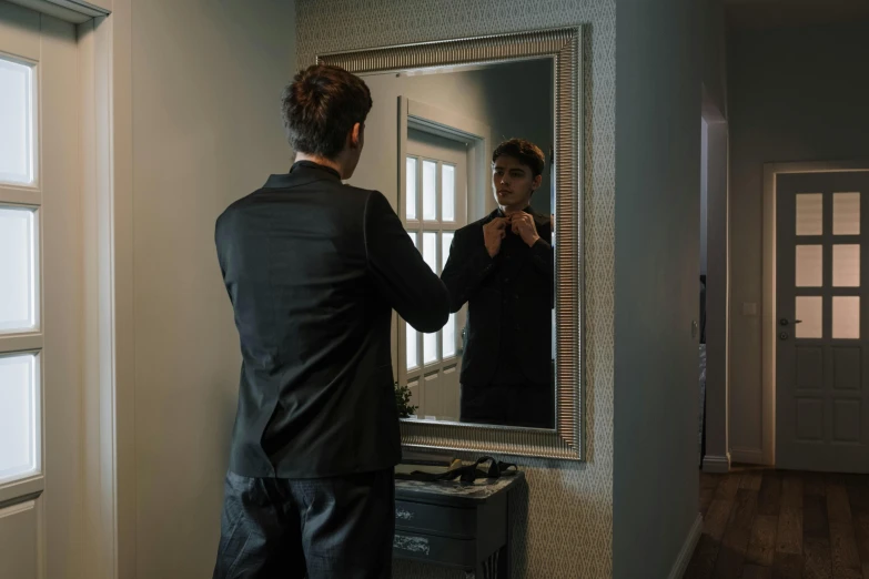 a man standing in front of a mirror brushing his teeth, by Elsa Bleda, hyperrealism, wearing a black suit, lachlan bailey, about to enter doorframe, teenage boy