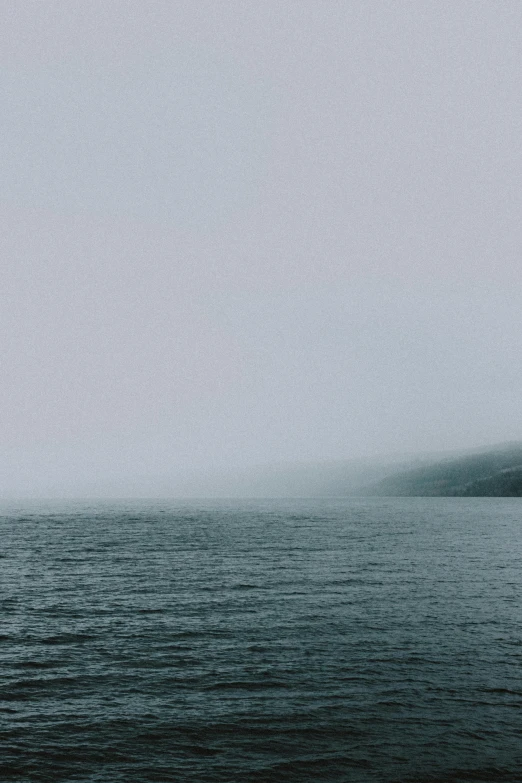 a black and white photo of a body of water, unsplash, romanticism, 2 5 6 x 2 5 6 pixels, green fog, gloomy colors, fjord