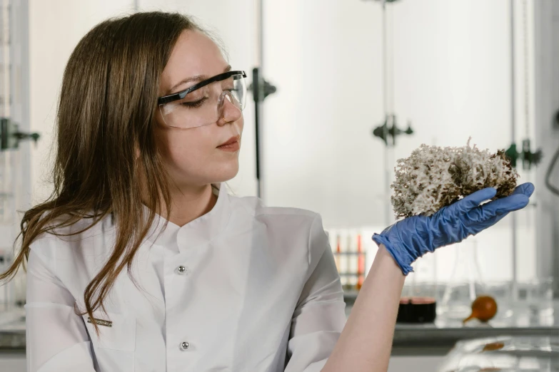 a woman in a lab coat holding a plant, pexels contest winner, academic art, made of dried flowers, avatar image, girl wearing uniform, mineral collections