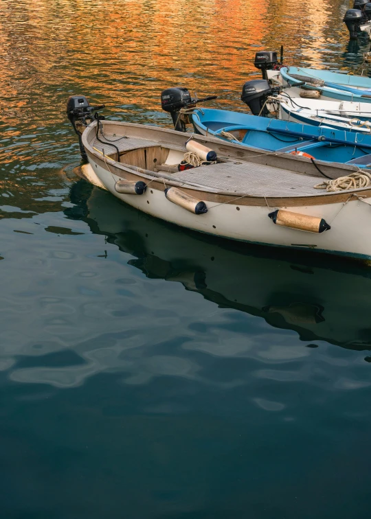 a number of small boats in a body of water, pexels contest winner, ivory and copper, italy, slide show, reflective light