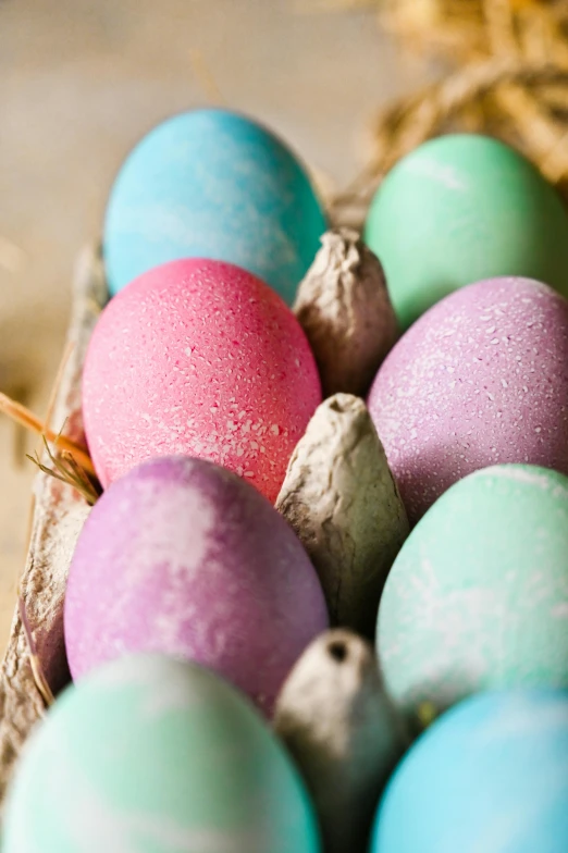 a basket filled with eggs sitting on top of a table, a pastel, magical sparkling colored dust, mauve and cinnabar and cyan, pink and blue and green mist, up close