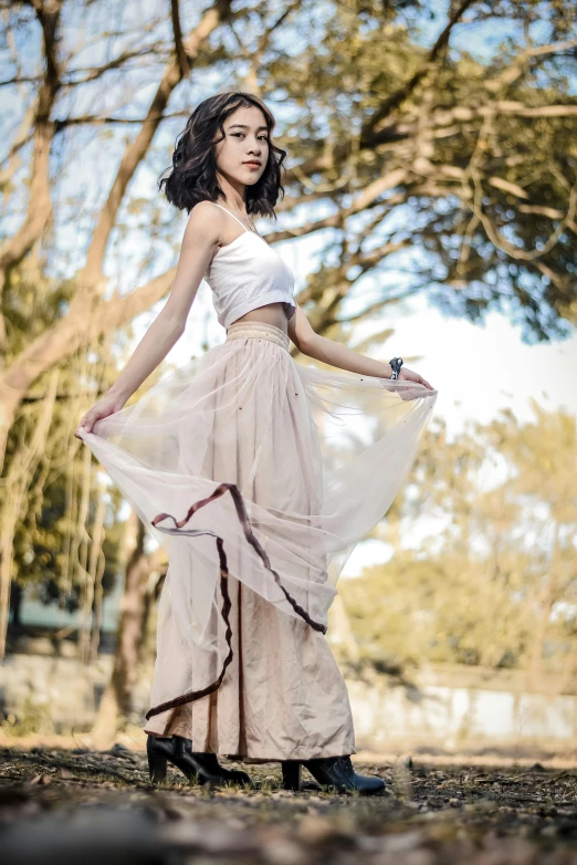 a woman that is standing in the dirt, a picture, trending on pexels, renaissance, long skirt, a young asian woman, wearing off - white style, 15081959 21121991 01012000 4k