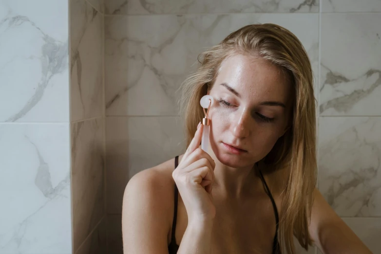 a woman brushing her teeth in a bathroom, by Emma Andijewska, trending on pexels, her face in discs, girl with a pearl earringl, gif, sleepy fashion model face