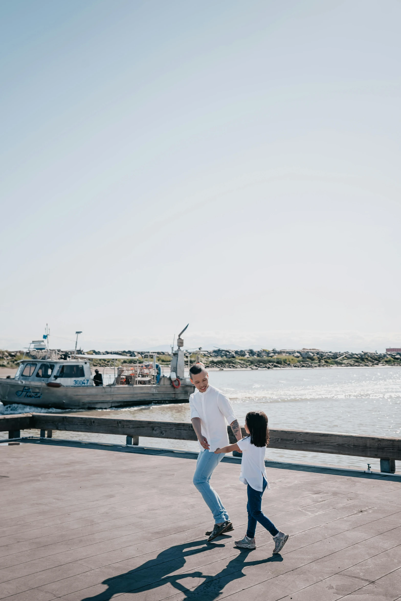 a man and a little girl are walking by the water, happening, harbour in background, cool dad vibes, uncropped, clean image