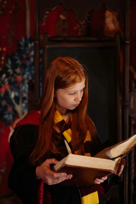 a girl in a harry potter costume reading a book, pexels, pre-raphaelitism, weta workshop, still from a movie, gif, promotional image