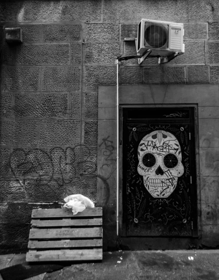 a black and white photo of a door with a skull on it, a black and white photo, by Géza Mészöly, street art, subject: dog, edinburgh, sugar skull, photo of scp-173