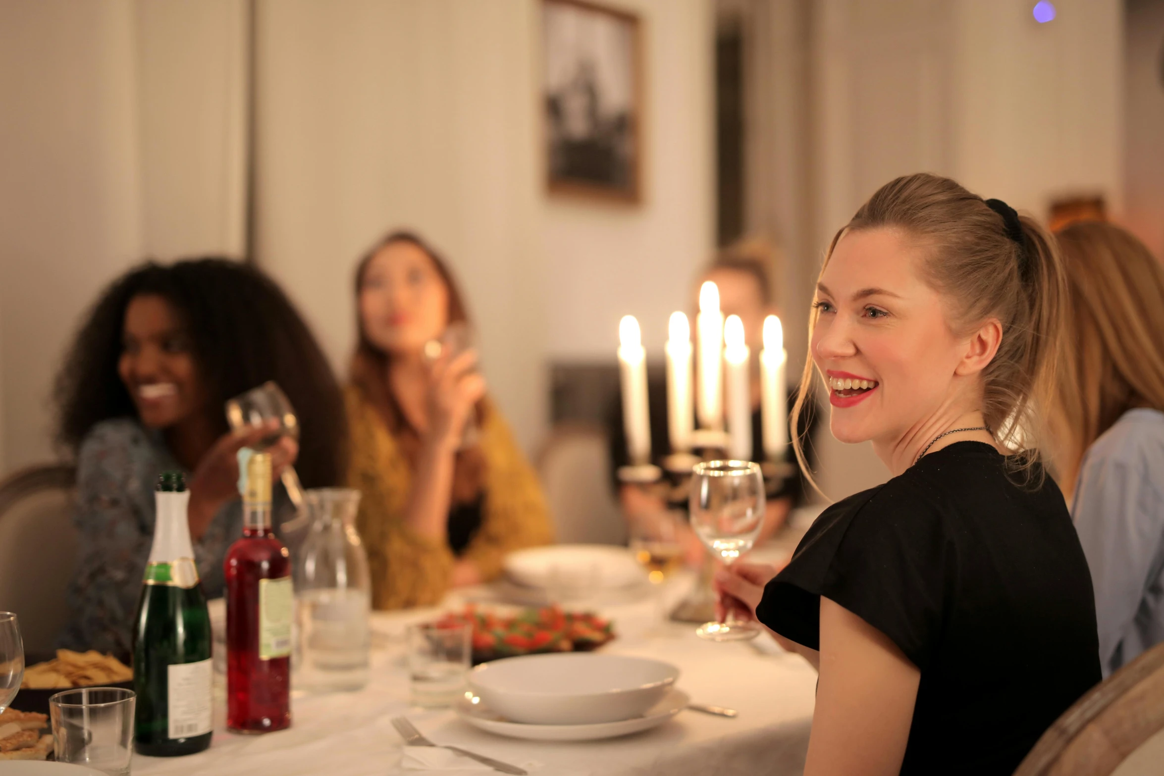 a group of people sitting around a dinner table, profile image, happy girl, natural candle lighting, hammershøi