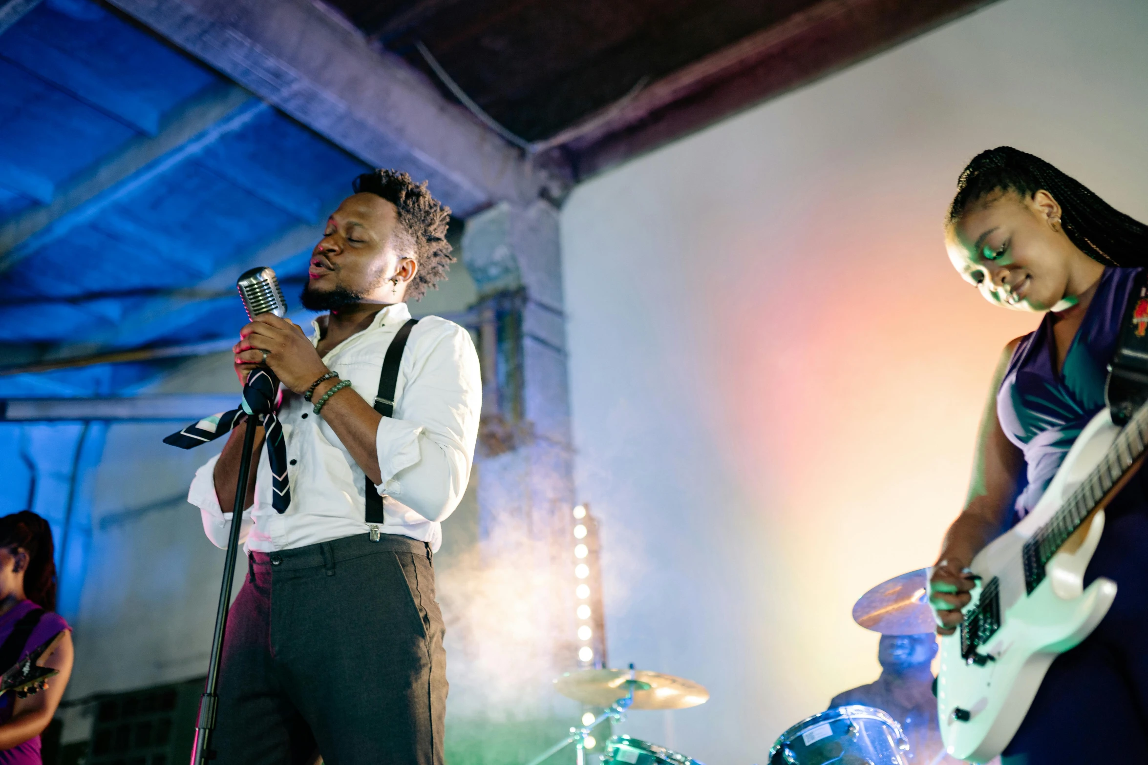 a man standing next to a woman on a stage, an album cover, pexels, black arts movement, wedding, band playing, brightly-lit, thumbnail