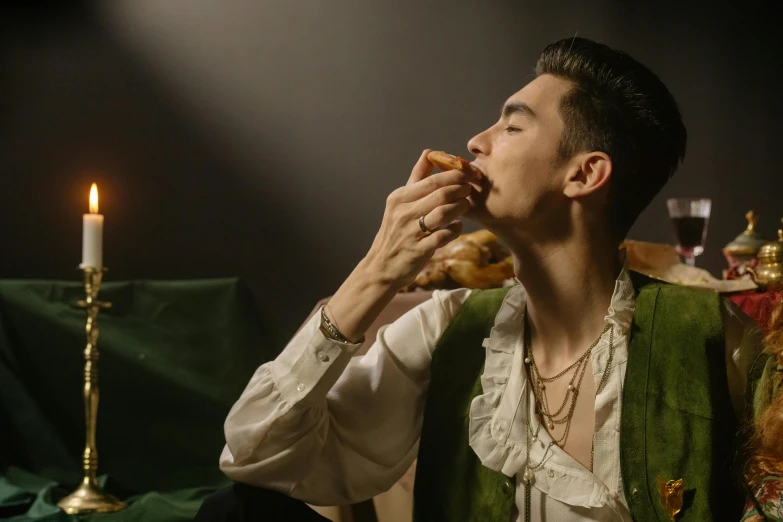 a man in a green vest eating a donut, inspired by Théodore Chassériau, trending on pexels, renaissance, cai xukun, !!posing_as_last_supper, pose 4 of 1 6, renaissance prince