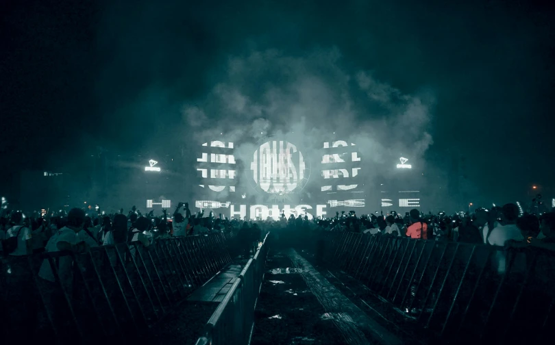 a crowd of people standing in front of a building, inspired by Mike Winkelmann, unsplash contest winner, “house music rave with dancers, dark hazy room, oasis, in the middle of an arena