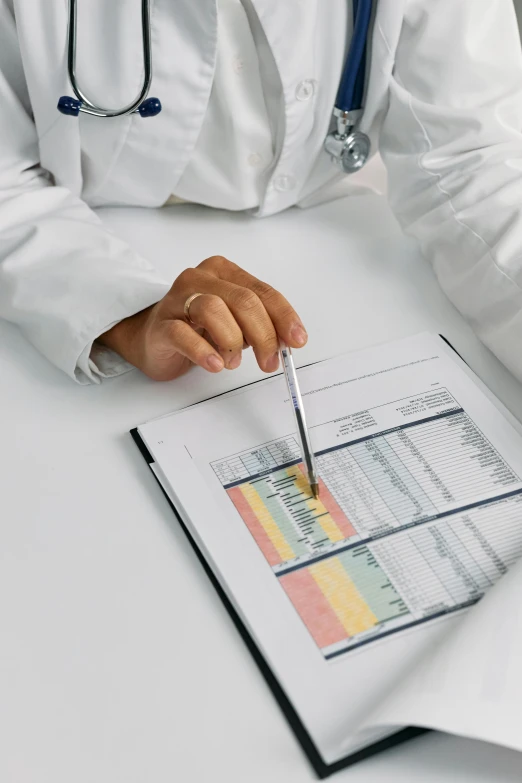 a man in a white lab coat writing on a piece of paper, unsplash, data visualization, multiple stories, medical book, pastel'