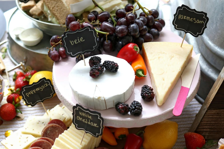 a table topped with lots of different types of cheese, by Alice Mason, labels, featured, fruit, background image