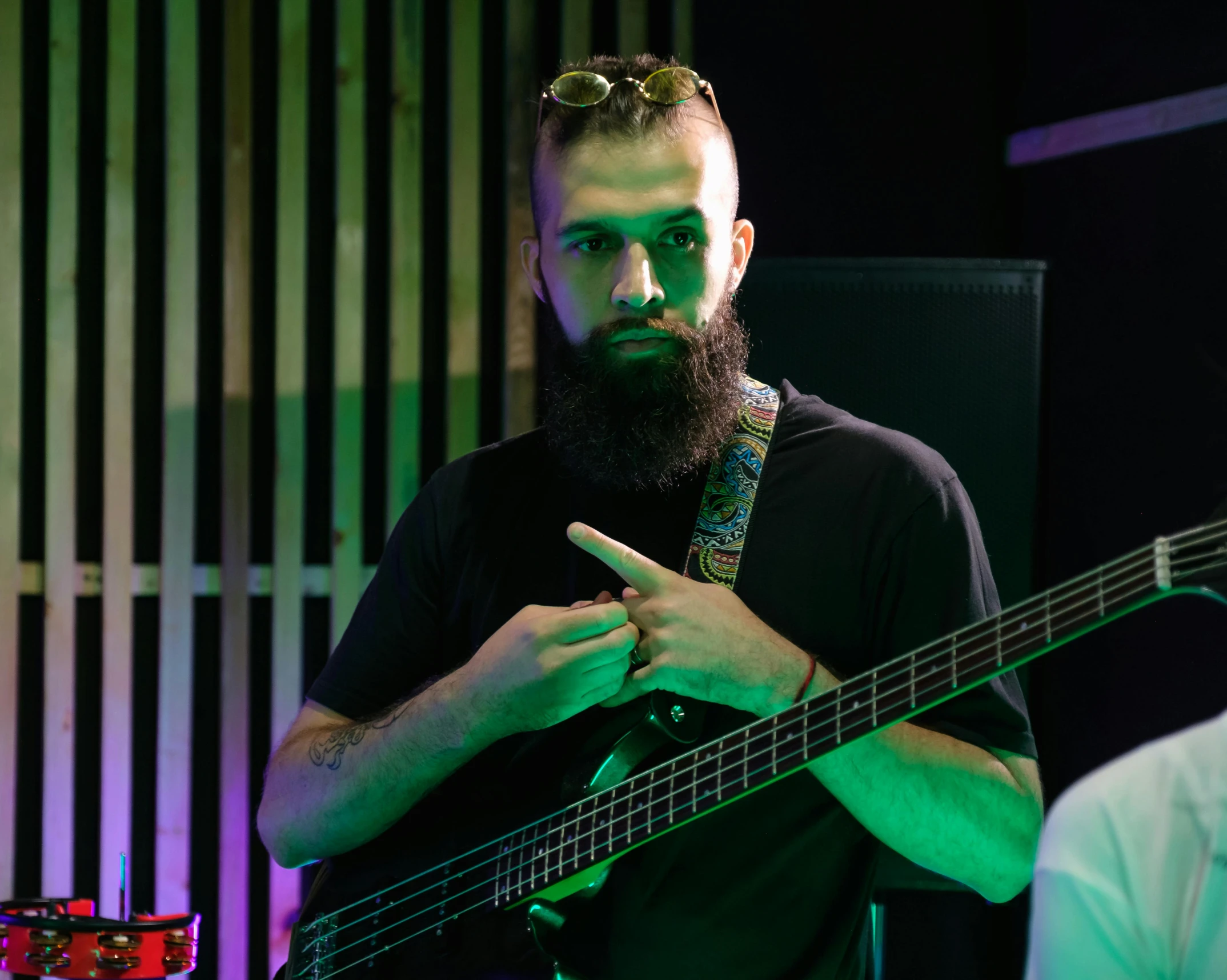 a man with a beard playing a bass guitar, pexels contest winner, hurufiyya, charli bowater and artgeem, looking to his side, sam nassour, technical