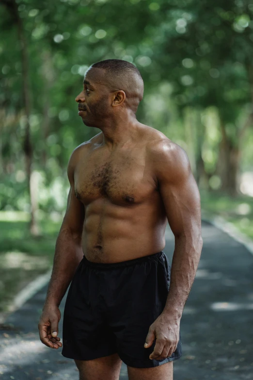 a man standing in the middle of a road, inspired by Terrell James, renaissance, athletic muscle tone, at a park, 4 5 yo, with abs