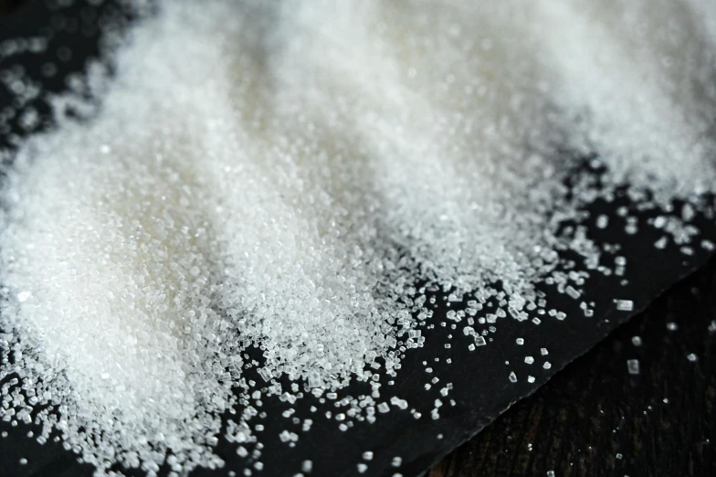 a pile of white sugar sitting on top of a table, a portrait, pexels, ldpe, glittery, waist - up, product shot