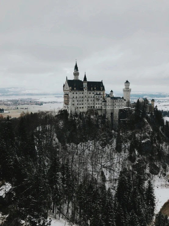 a castle sitting on top of a snow covered hill, pexels contest winner, german romanticism, 🎀 🧟 🍓 🧚, gloomy skies, college, album