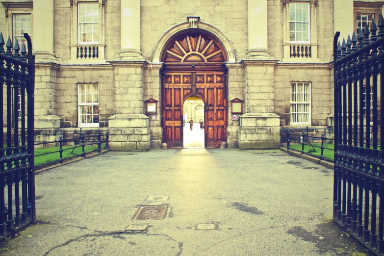 a large building with a gate in front of it, pexels contest winner, academic art, grain effect, bath, he is at college, 3 doors