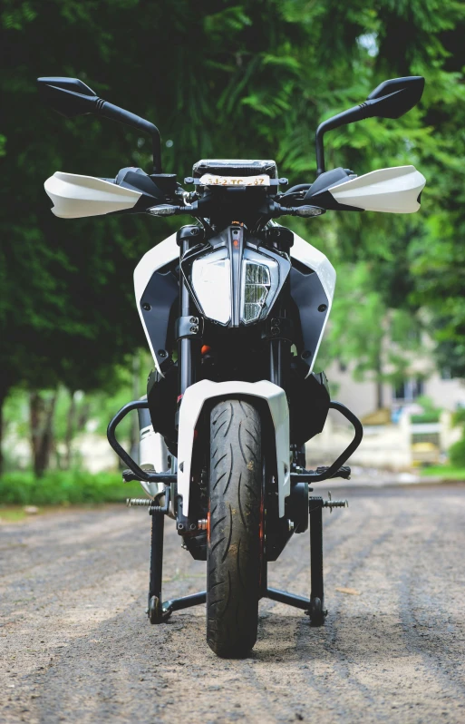 a motorcycle parked on the side of a road, white and black, avatar image, front facing shot, square