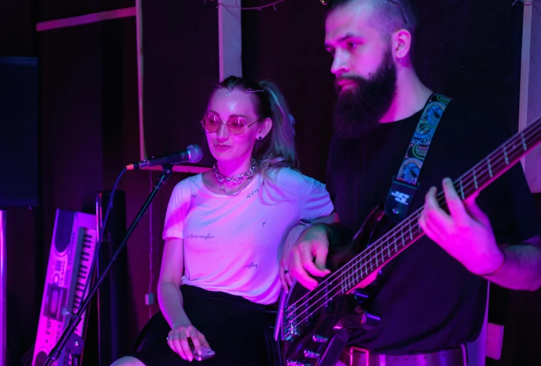 a man standing next to a woman holding a guitar, pexels, antipodeans, performing on stage, closed limbo room, charli bowater and artgeem, profile image