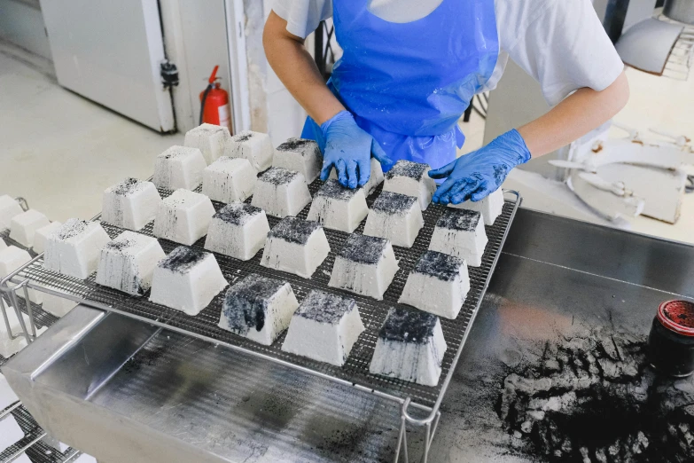 a person in a kitchen preparing food on a conveyor belt, a marble sculpture, unsplash, process art, cubes of ice around, oozing black goo, many cryogenic pods, white metal