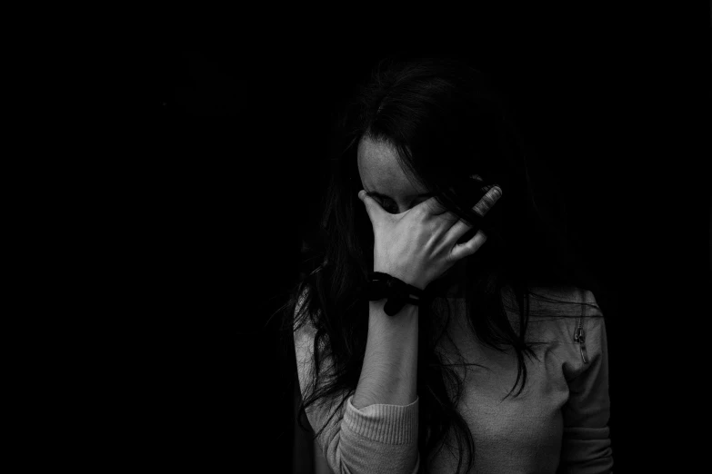 a black and white photo of a woman covering her face, trauma, 15081959 21121991 01012000 4k, heartbroken, woman with black hair