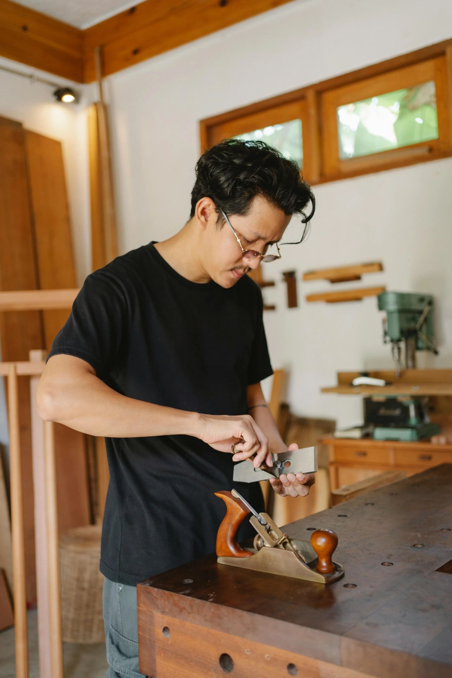 a man working on a plane in a wood shop, inspired by Joong Keun Lee, plating, sustainable materials, avatar image, wonbin lee