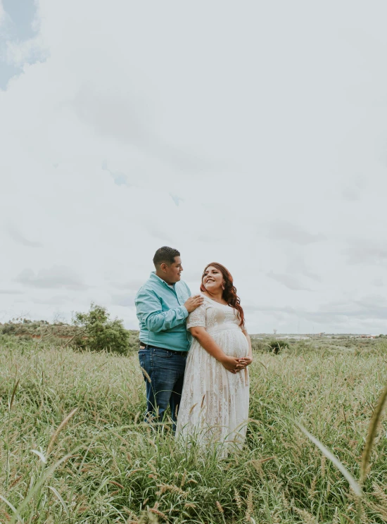 a pregnant woman standing next to a man in a field, unsplash, happening, brazilian, 2 5 6 x 2 5 6 pixels, plus size, multiple stories