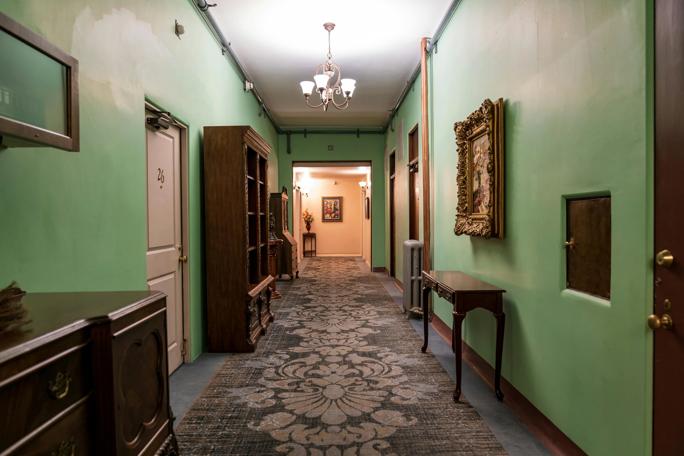 a long hallway with green walls and a chandelier, unsplash, art nouveau, office/thrift store/social hall, 5 th floor, an escape room in a small, profile image