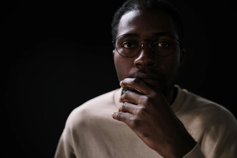 a close up of a person wearing glasses, by Barthélemy Menn, sitting with wrists together, portrait 8 k, godwin akpan, high quality image