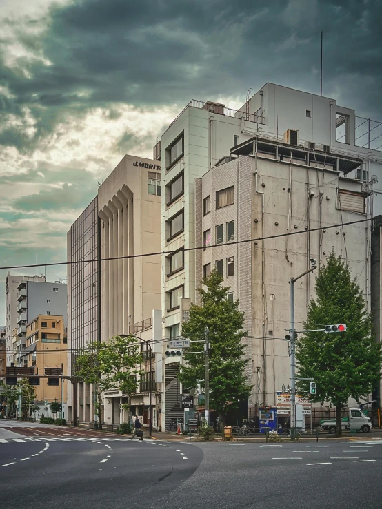 a very tall building sitting on the side of a road, a colorized photo, inspired by Tōshi Yoshida, unsplash, brutalism, today\'s featured photograph 4k, japanese town, late afternoon, highly detailed 8k photo