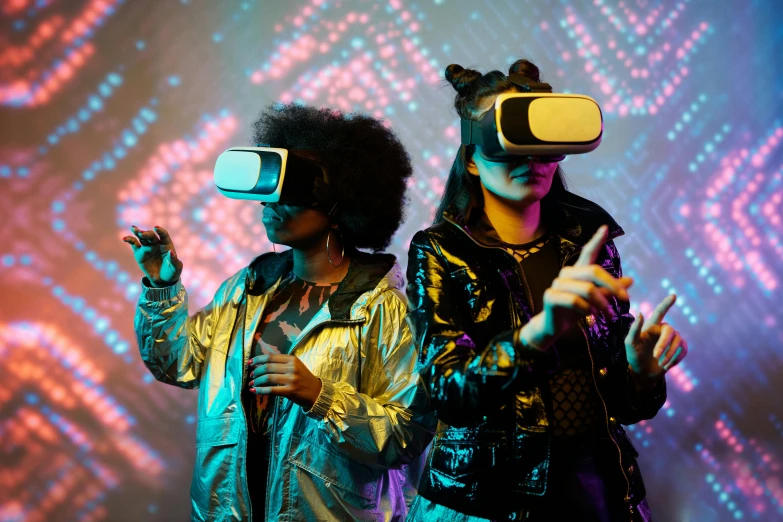 a couple of people standing next to each other on a stage, a hologram, pexels, interactive art, vr goggles, photograph of three ravers, cyberpunk childrens bedroom, cardboard