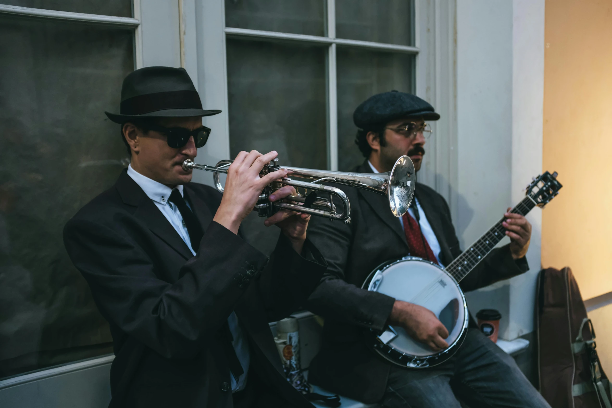 a couple of men that are playing musical instruments, by Emma Andijewska, unsplash, costumes from peaky blinders, 15081959 21121991 01012000 4k, jazz quintet, in paris