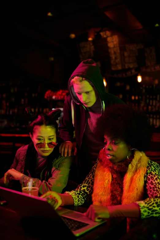 a group of people sitting around a laptop computer, voodoo, neon basement, ( ( theatrical ) ), intense knowledge