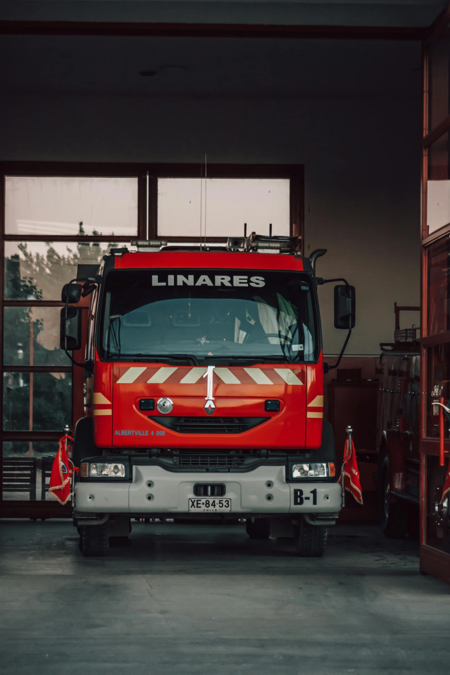 a red fire truck parked in a garage, a picture, pexels contest winner, les nabis, anato finnstark. front view, square, french, mines