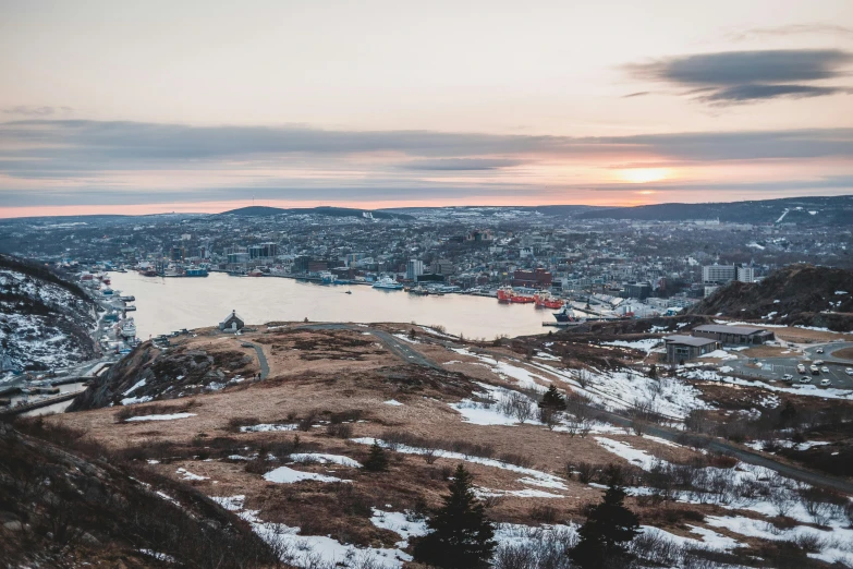 a large body of water sitting on top of a snow covered hillside, a photo, pexels contest winner, happening, harbour in background, taken at golden hour, notan, viewed from above