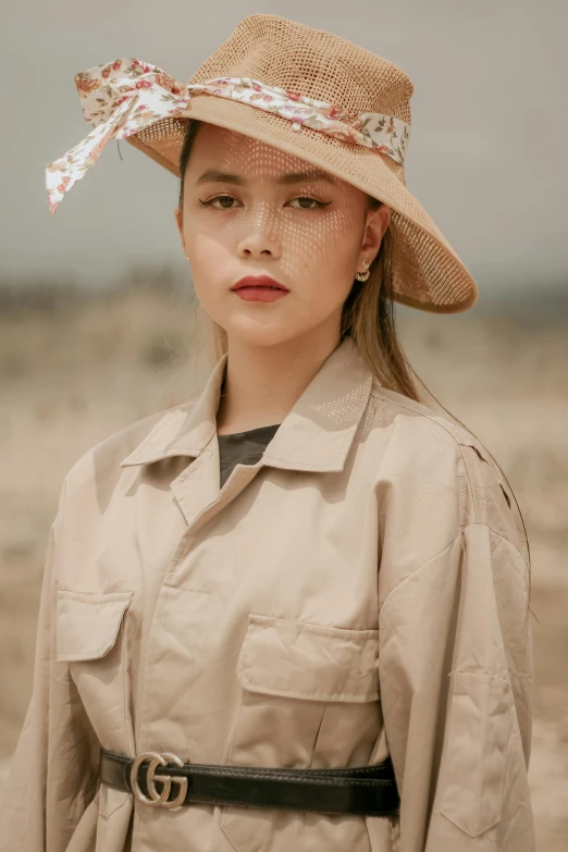 a woman standing in the desert wearing a hat, a colorized photo, inspired by Ruth Jên, trending on pexels, wearing a linen shirt, close up face, wenjun lin, she is wearing streetwear