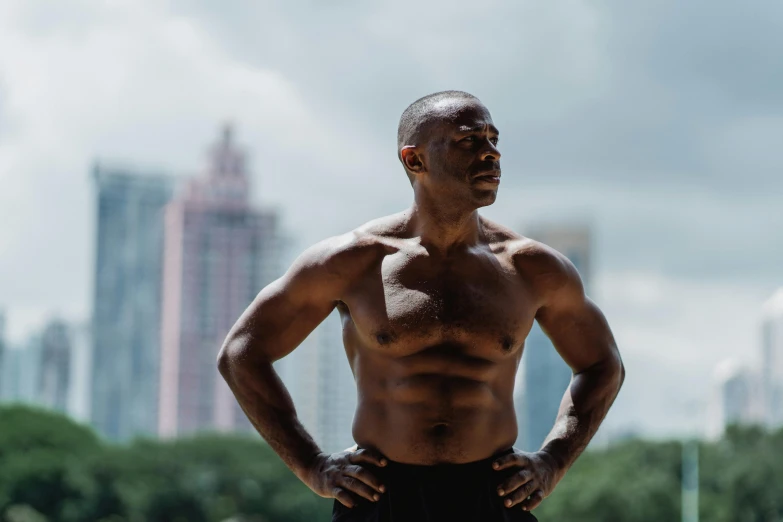 a man standing with his hands on his hips, by Sam Charles, pexels contest winner, figuration libre, sweaty abs, atiba jefferson, with a city in the background, mid - 3 0 s aged